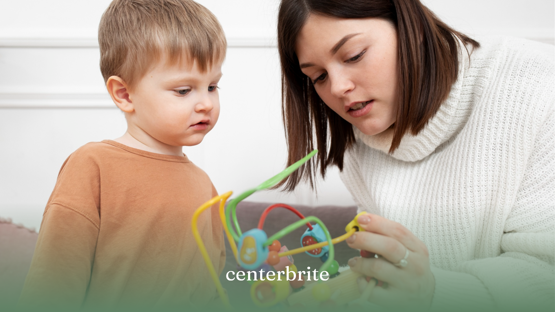 A kid and a BCBA playing with educational toys during ABA therapy